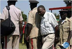 Chief mwanachingwala makes his way among the kapasos or Aid' de camps at his palace in Mazabukua