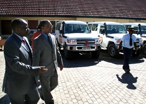 Health Minister Kapembwa Simbao and National AIDS Council director general Ben Chirwa (l) inspect vehicles that were handed over to the council in Lusaka