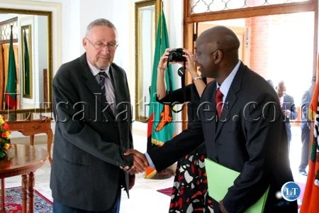 Newly appointed Vice President Guy Scott shakes hands with a member of staff on his arrival at State House in Lusaka