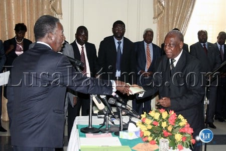 President Michael Sata receives an affidavit from newly appointed