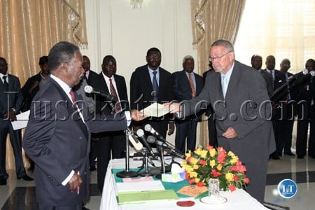 President Michael Sata receives an affidavit from Vice President Guy
