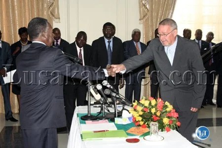 President Michael Sata shakes hands with Vice President Guy Scott at